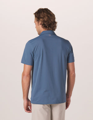 Fore Stripe Performance Polo in Mineral Blue On Model from Back