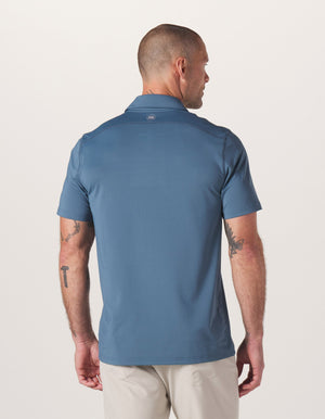 Normal Script Performance Polo in Mineral Blue On Model from Back