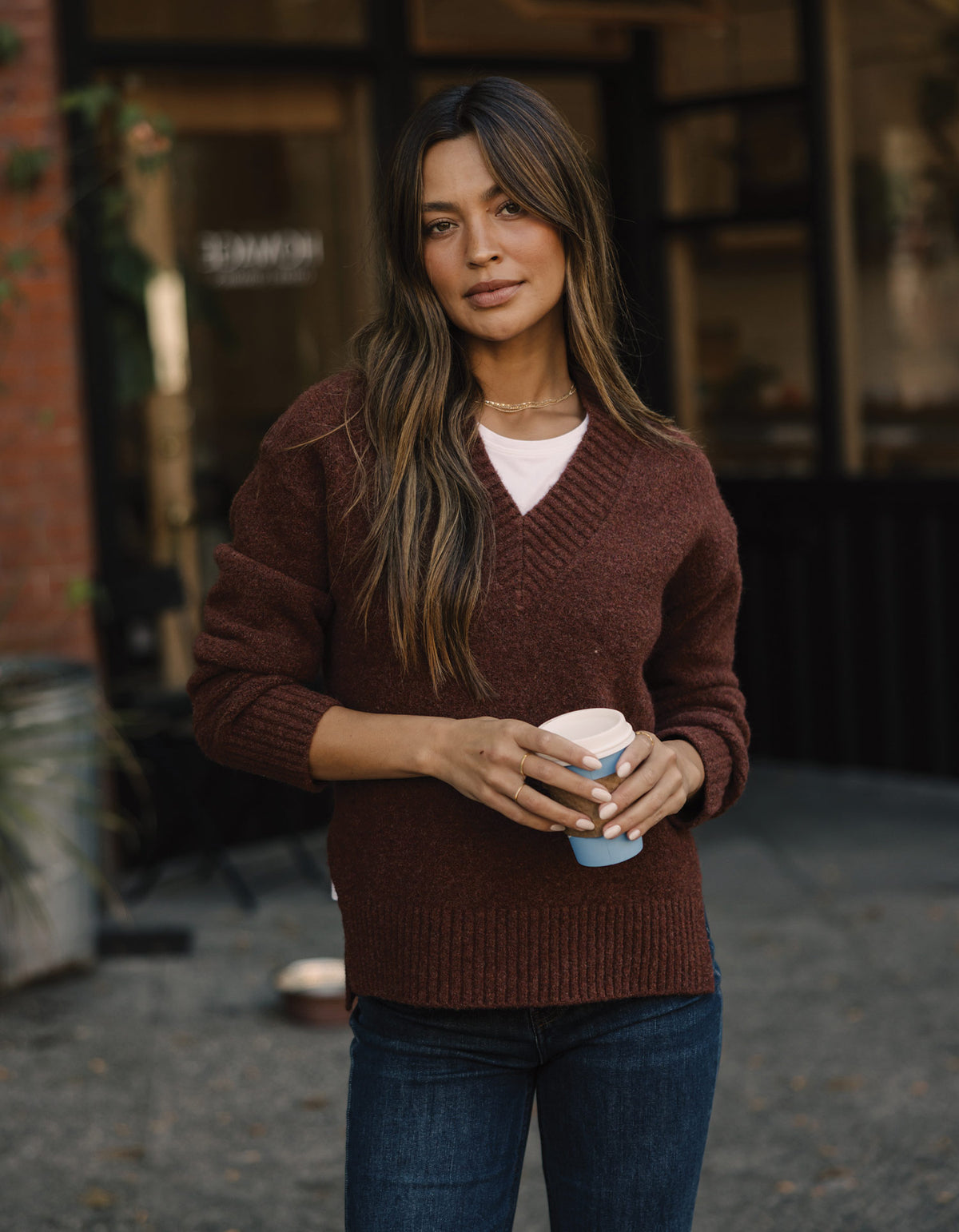 Homebound V-Neck Sweater in Spiced Brandy — outdoor front view on model