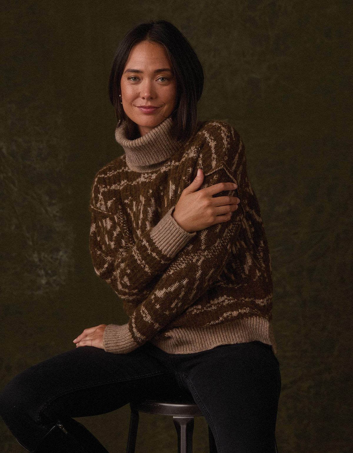 Freya Sweater in Hickory Multi — seated studio view on model