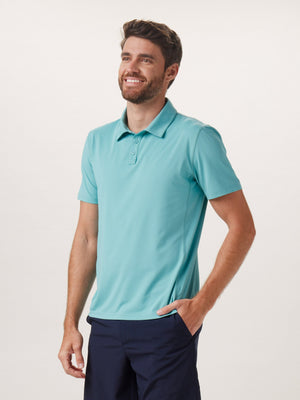 Cross-Back Seamed Performance Polo in Turquoise On Model from Front
