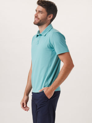 Cross-Back Seamed Performance Polo in Turquoise On Model from Side
