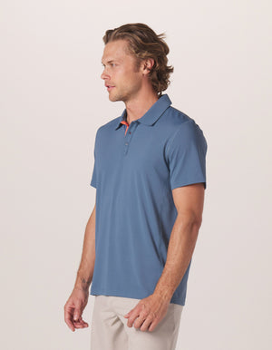 Cross-Back Seamed Performance Polo in Mineral Blue On Model from Side