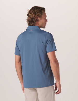 Cross-Back Seamed Performance Polo in Mineral Blue On Model from Back