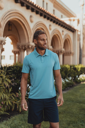 Cross-Back Seamed Performance Polo in Turquoise On Model outside